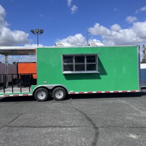 Quality Cargo 8.5x26 green BBQ trailer featuring an 8-foot porch, dual air conditioners, hood vent, sink package, and concession window for sale.