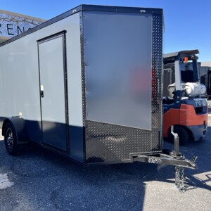 Deep South 6x12 enclosed trailer with charcoal Polycore exterior, blackout package, alloy wheels, spoiler, and ramp door.