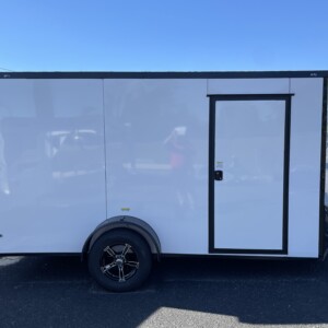 Deep South 6x12 single axle enclosed trailer with white Polycore exterior, blackout package, alloy wheels, spoiler, and ramp door. Image Caption