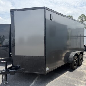 Deep South 7x14 tandem axle enclosed cargo trailer in charcoal gray with blackout package, 7-foot interior height, Polycore semi-screwless exterior, rear spoiler with LED light, alloy wheels, ramp door, and side entry door.