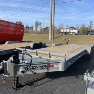 Southern Utility 7x24 tandem axle equipment trailer in grey with heavy-duty ramps, toolbox, black wheels, and treated wood deck.