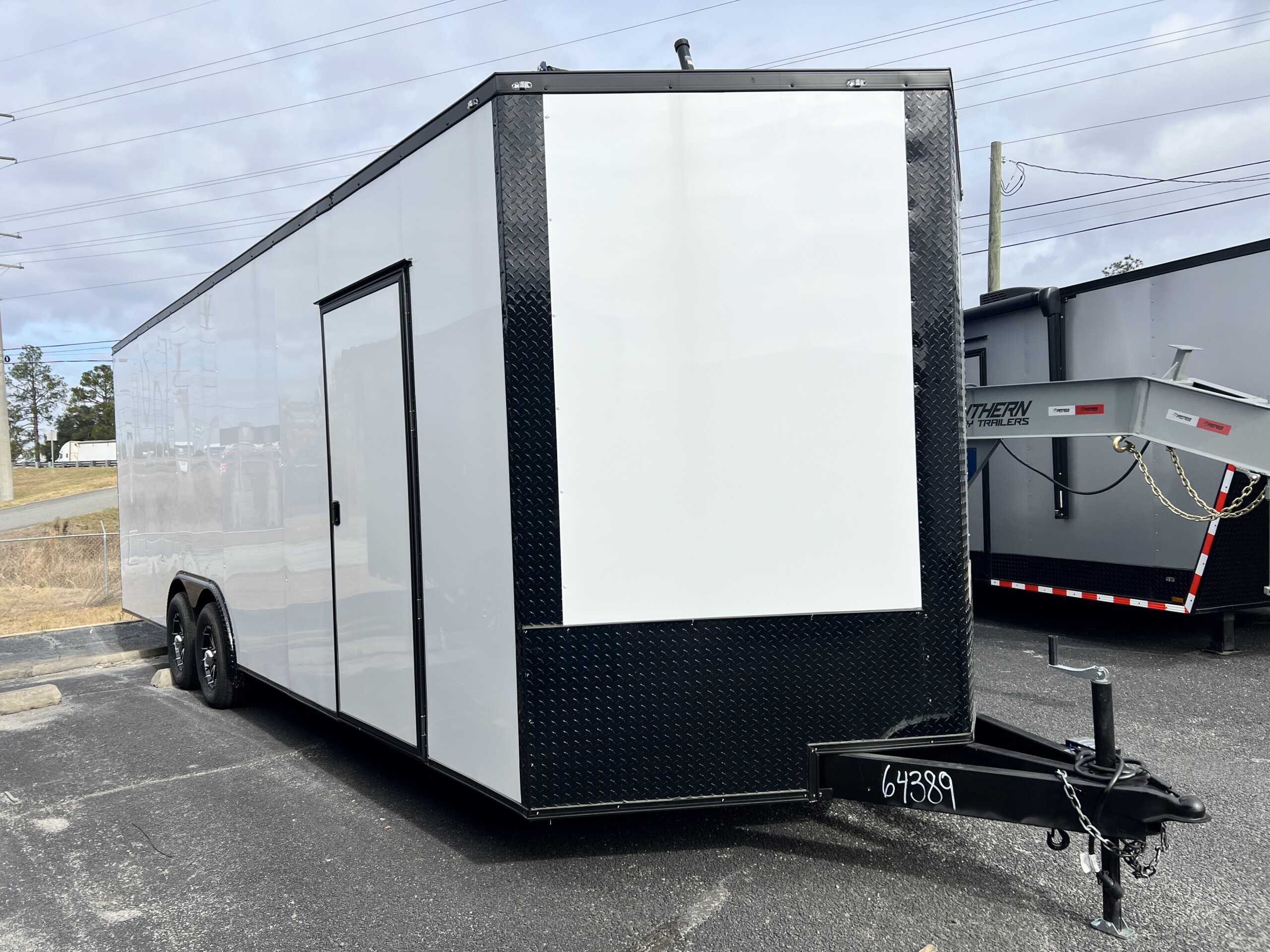 Deep South 8.5x24 enclosed car hauler with Polycore exterior, blackout package, escape door, screwless exterior, and mag wheels.