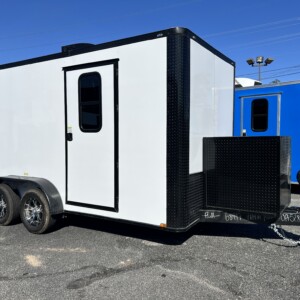 White 7x14 tandem axle pet grooming trailer with blackout trim, Flying Pig tub, water tanks, cabinets, air conditioning, and generator box