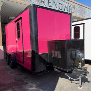 Pink Genesis Series 7x14 mobile pet grooming trailer with blackout trim, Flying Pig tub, water tanks, generator compartment, alloy wheels, and air conditioning.