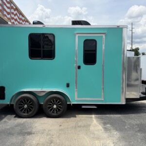 Turquoise and chrome Legacy Series 7x14 mobile grooming trailer with battery power system, Flying Pig tub, electric grooming table, K9 dryer, and premium grooming interior.