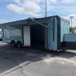 Rock Solid Cargo 8.5x28 enclosed race car trailer in greyish blue with blackout trim, spread torsion axles, electric awning, generator compartment, and custom race package.