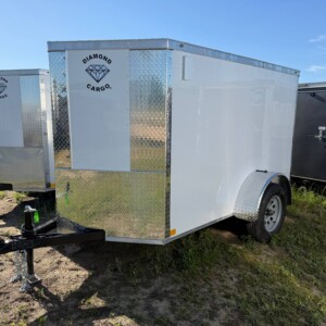 Diamond Cargo 5x8 enclosed cargo trailer with Polycore exterior, V-nose design, ramp door, LED lights, and silver modular wheels.