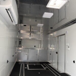 Rock Solid 8.5x32 race car trailer with white and silver exterior, RTP flooring, E-track, winch, awning, and mini split A/C.