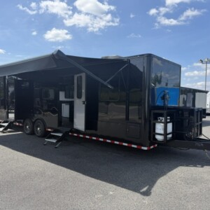 Rock Solid Cargo 8.5x30 custom cargo camper and toy hauler with bedroom, bathroom, kitchenette, garage and generator
