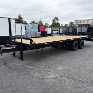 Black 8.5x25 Mid-South heavy-duty deckover equipment trailer with treated wood deck, tandem axles, self-cleaning dovetail and mega loading ramps.