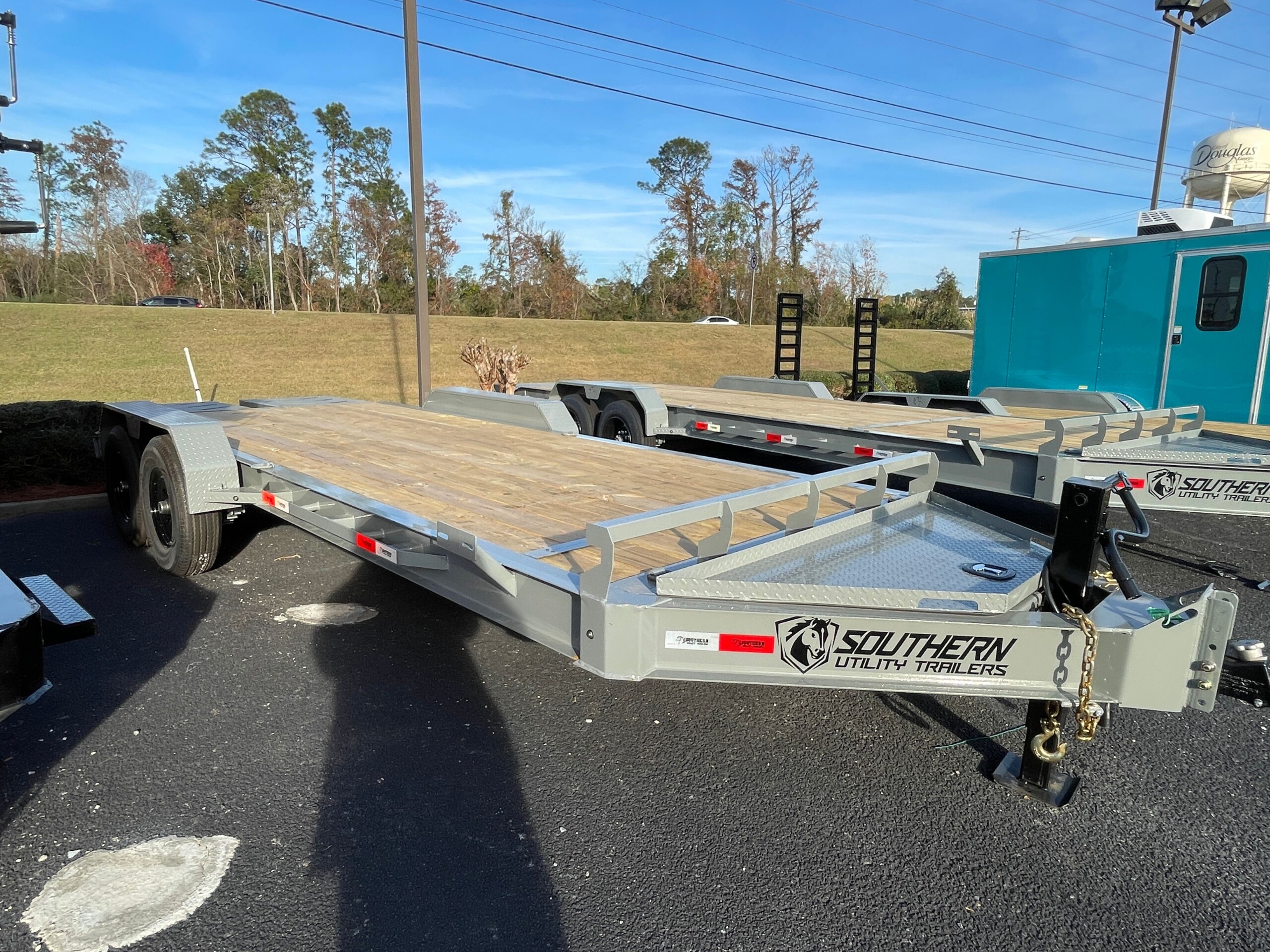 Southern Utility 7x20 tandem axle 14K equipment trailer with heavy-duty I-beam frame, treated wood deck, integrated toolbox and mini pony ramps.