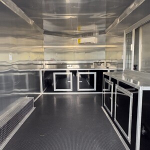 Black Kingsforge 8.5x16 tandem axle concession food trailer with blackout exterior package and 3' x 6' concession serving window.