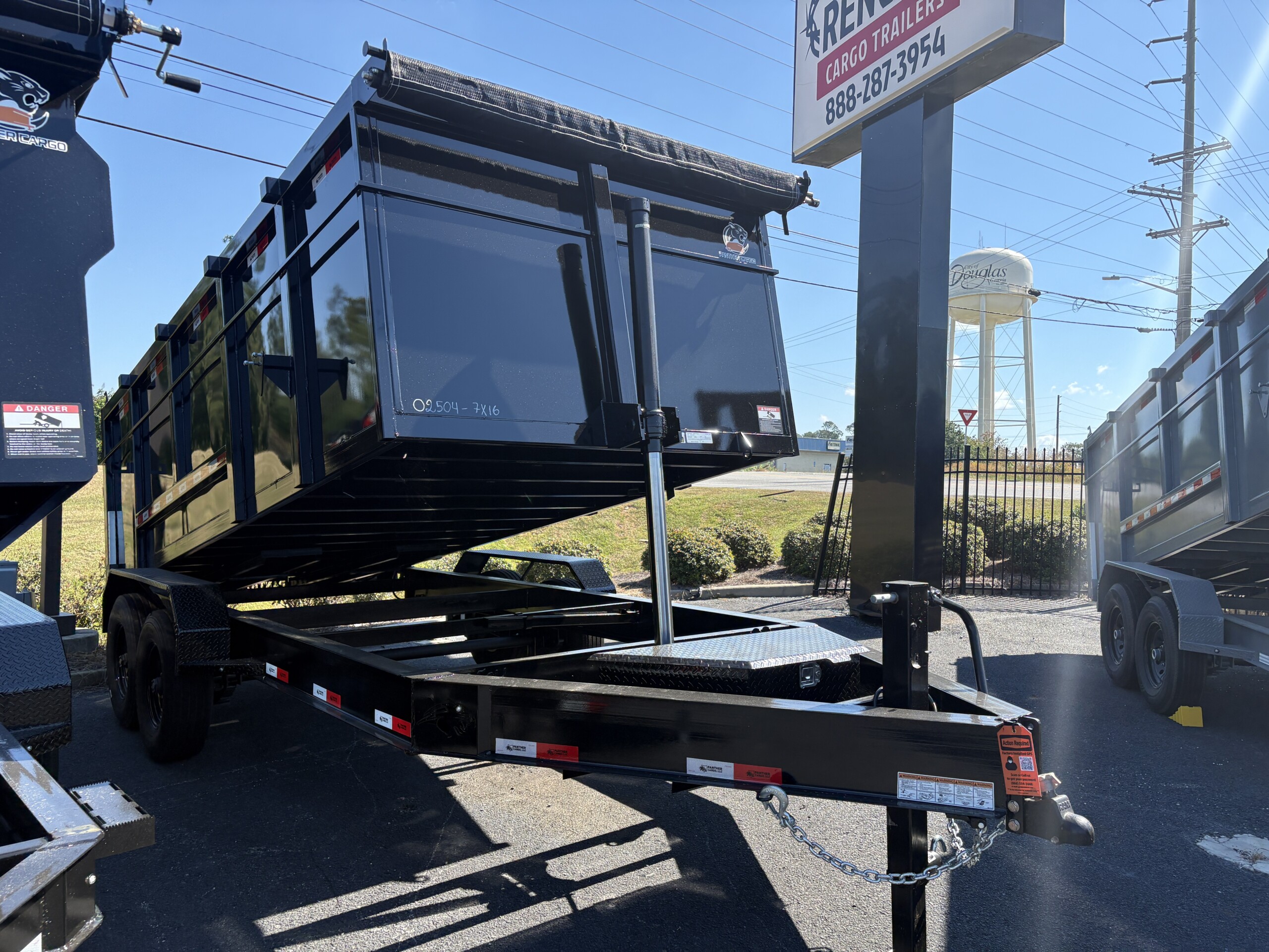 Black Panther Cargo 7x16 tandem axle dump trailer with 4-foot steel walls, heavy-duty steel dump bed, rear barn doors and tarp system.
