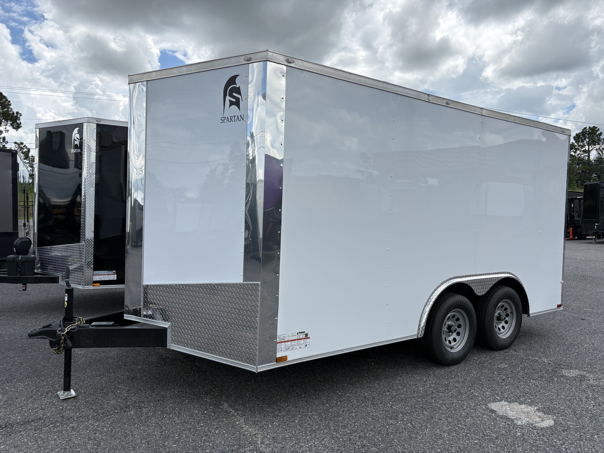 Spartan Cargo 8.5x14 tandem axle enclosed cargo trailer with V-nose, rear ramp door, aluminum exterior and 6-inch tubular frame.