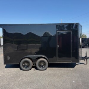 J&C Cargo 7x14 tandem axle enclosed cargo trailer with black Poly exterior, blackout package, 7-foot interior height, black wheels and rear spoiler.